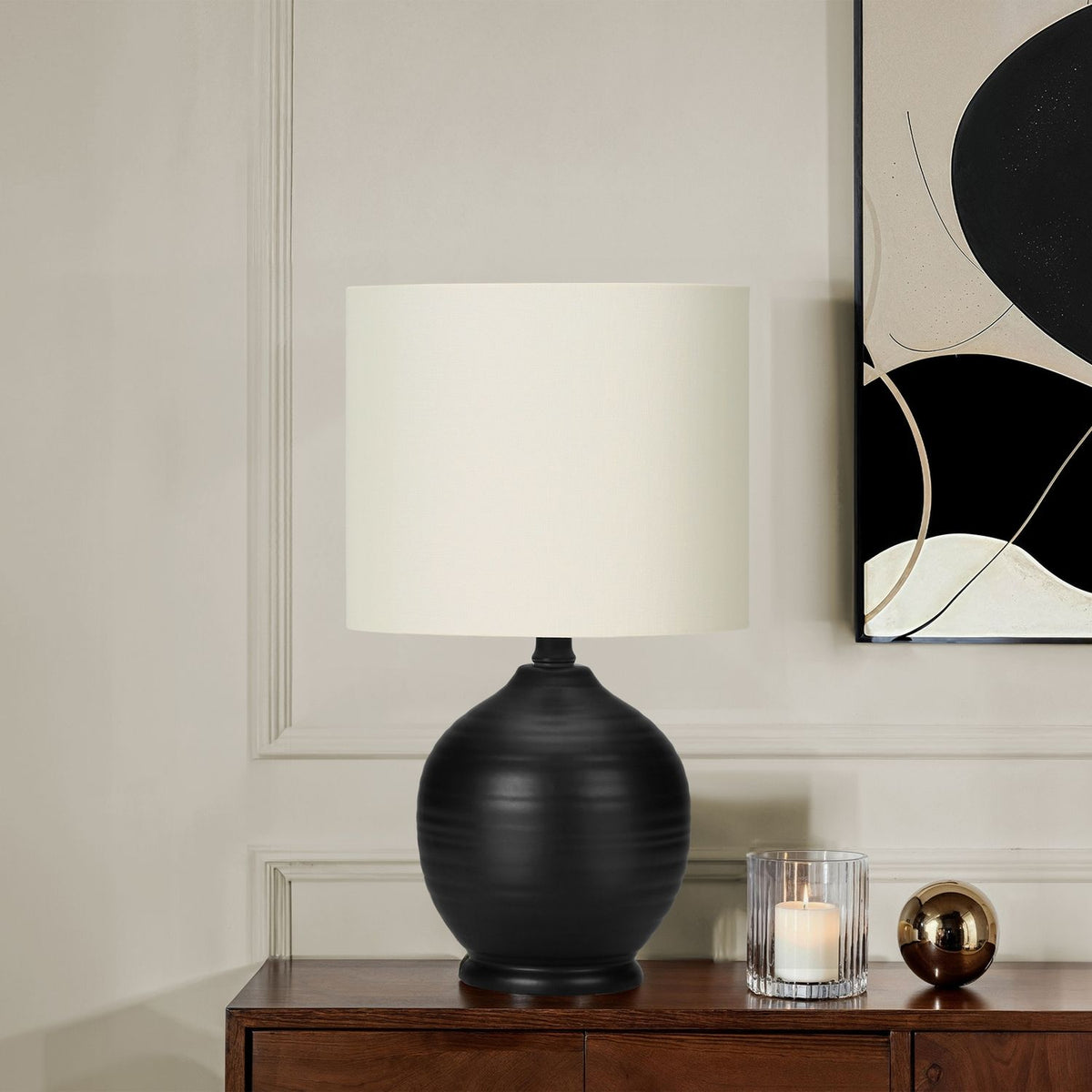 Black ceramic table lamp styled on a side table