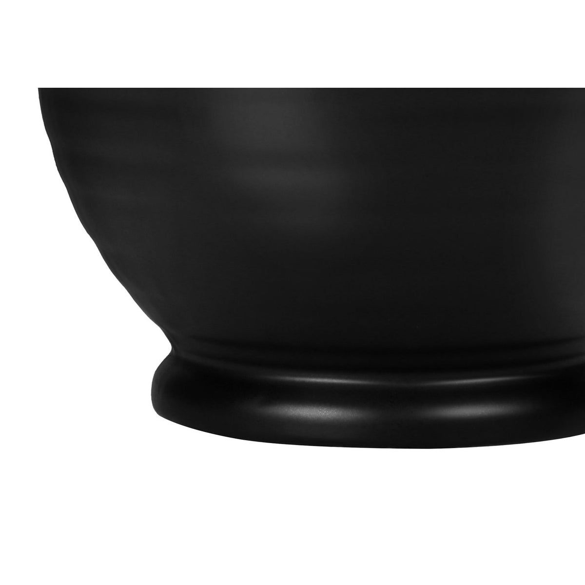 Close-up of the textured black ceramic lamp base